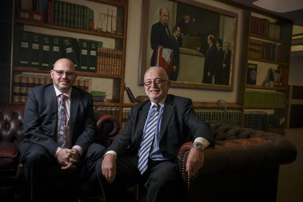 Ronald and Brett Tait seated in the firm's library